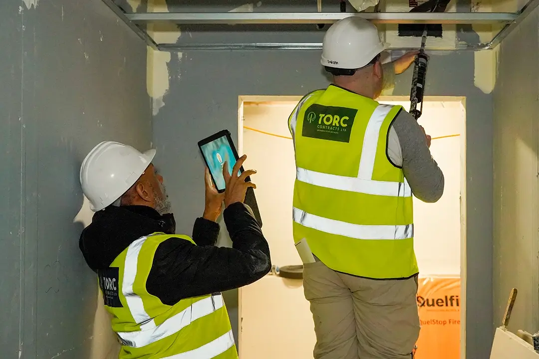 Torc Contracts employees photographing the sealant gun application copy